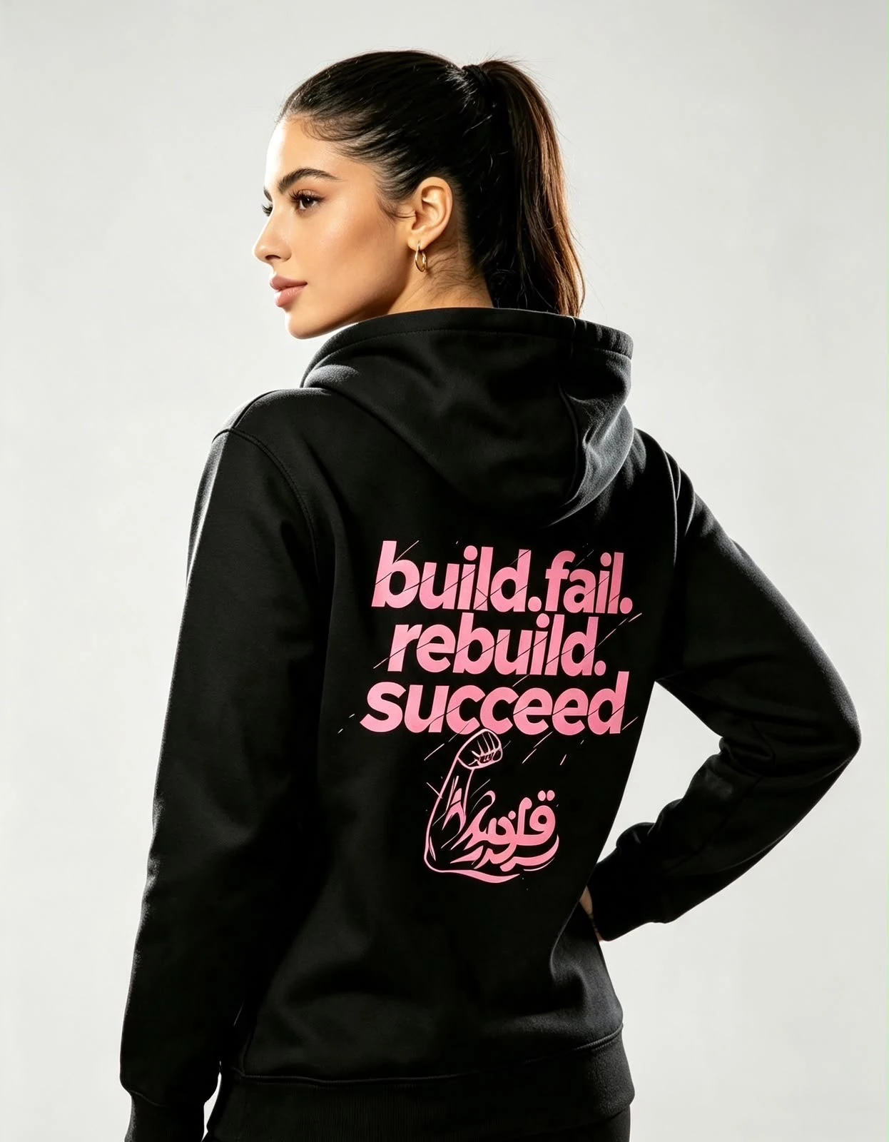 Back of black Quwwah hoodie with rose pink build fail rebuild succeed print